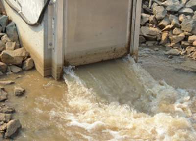 Channel water being released through a flume gate