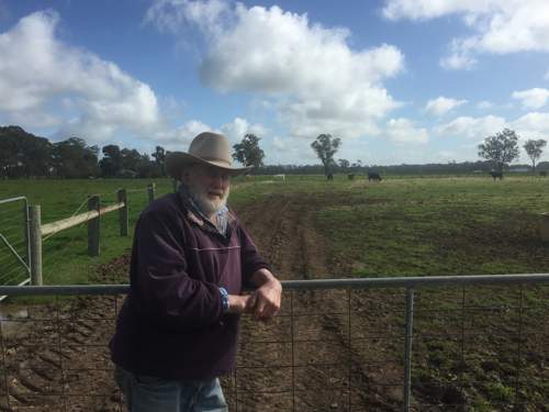 Farmer Ross Stammers leans on a gate at the entrance to one of his paddocks.