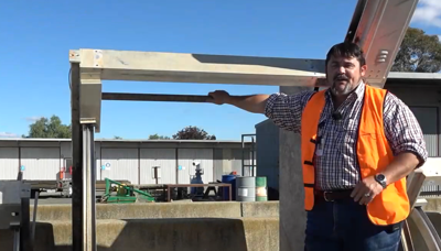 A man leaning on a flume gate