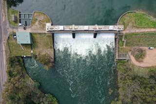 A picture of a dam with water running